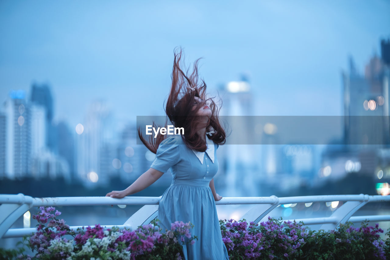 rear view of woman standing by railing