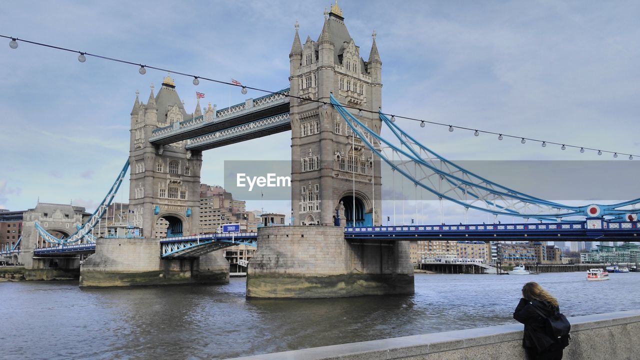 Low angle view of tower bridge over river against sky