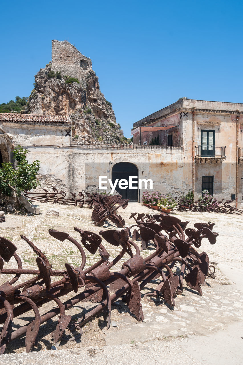 DAMAGED BUILDING AGAINST CLEAR BLUE SKY