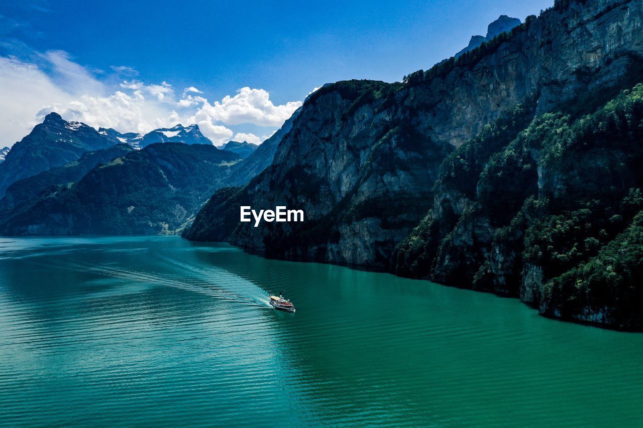 Scenic view of mountains against blue sky