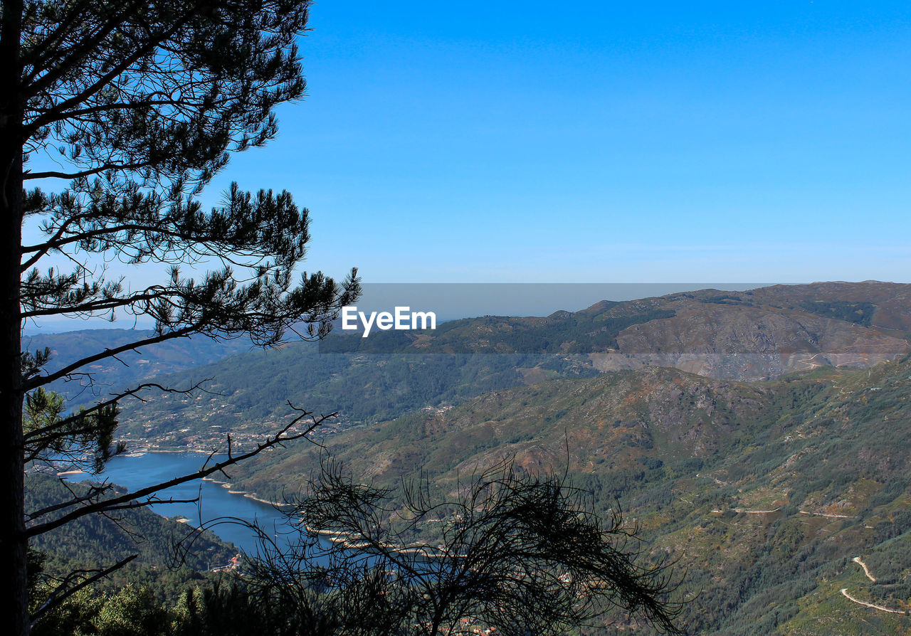 Scenic view of mountains against clear blue sky