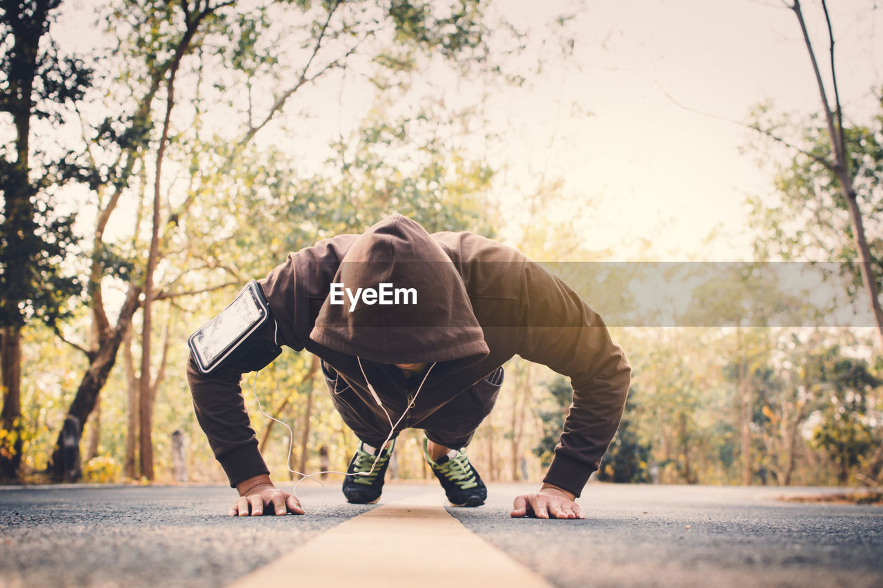 Man exercising on road