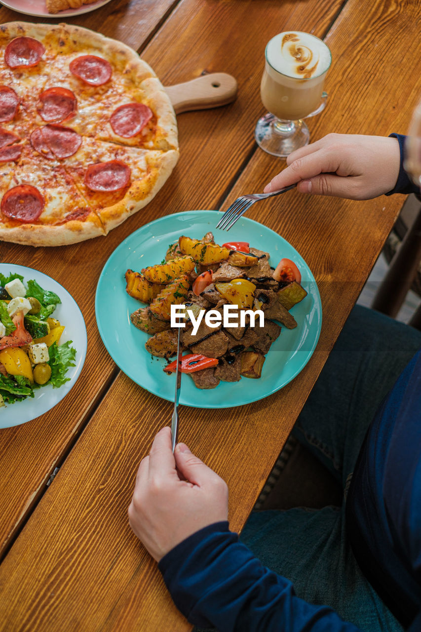 midsection of man with food in restaurant