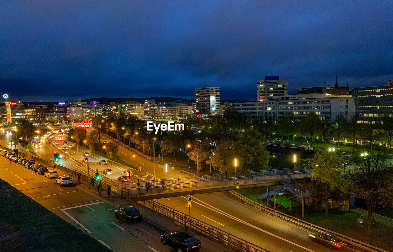 High angle view of illuminated cityscape against sky at night