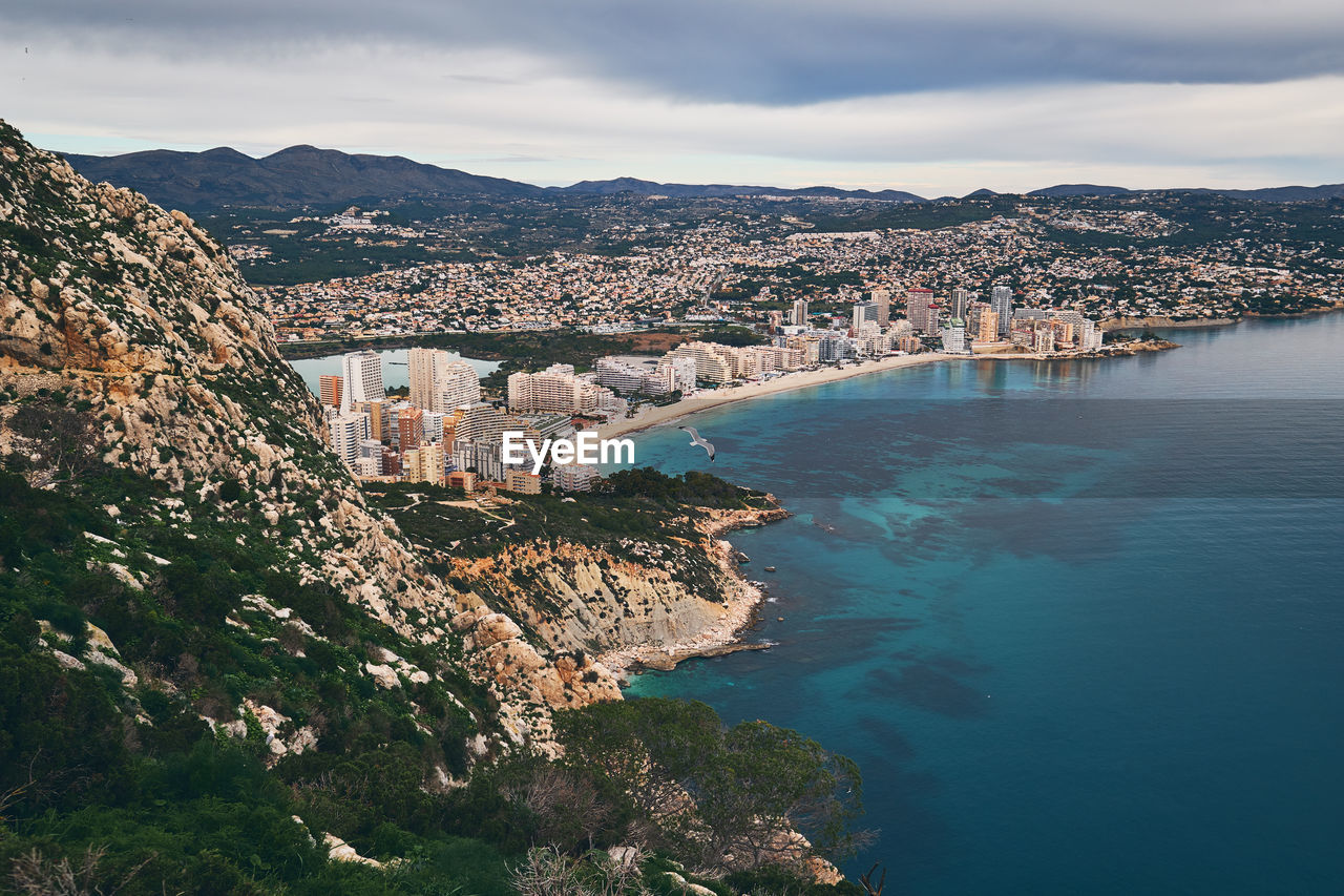 Aerial view of city and buildings against sky