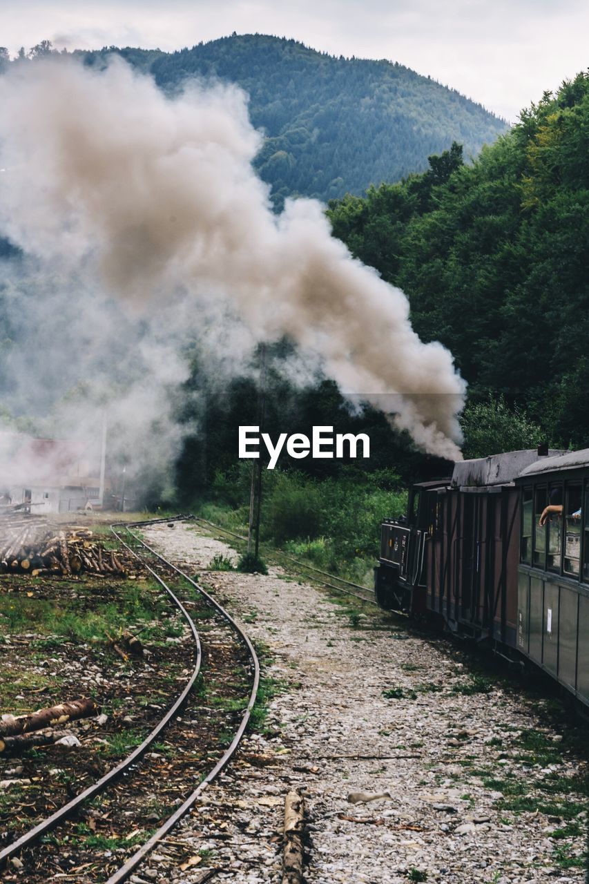 Smoke emitting from train on railroad track