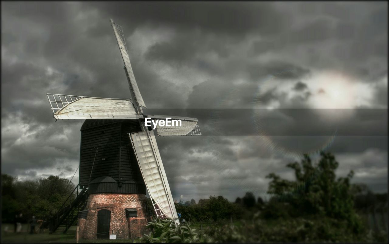 Traditional windmill against overcast sky