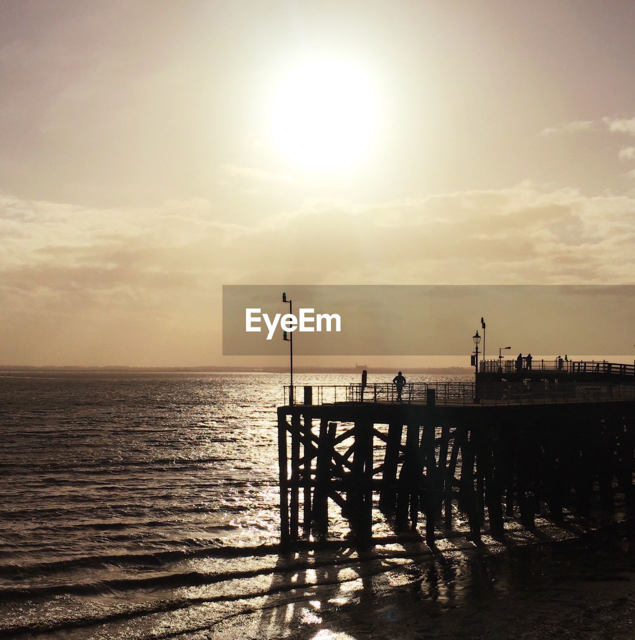 Silhouette of pier at sunset