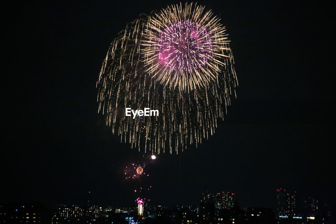 Low angle view of firework display at night