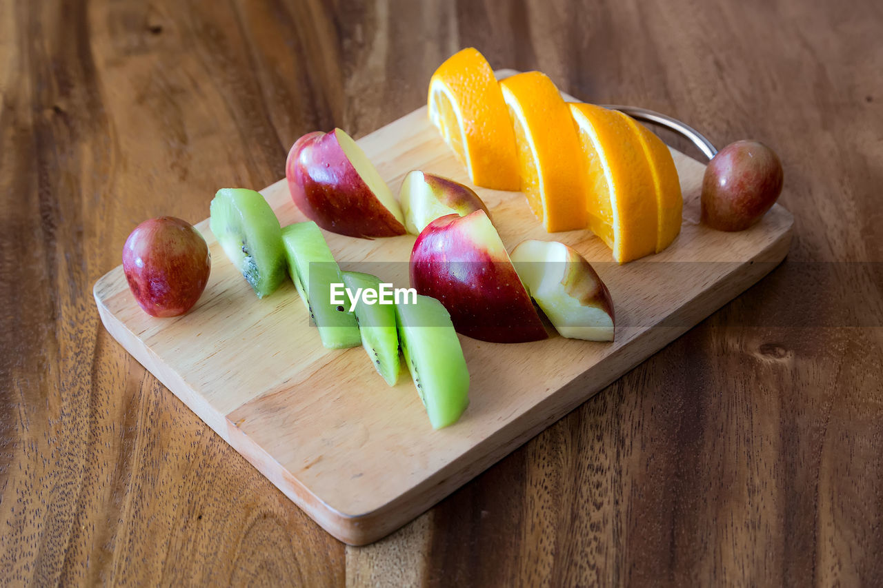 High angle view of fruits and vegetables on cutting board