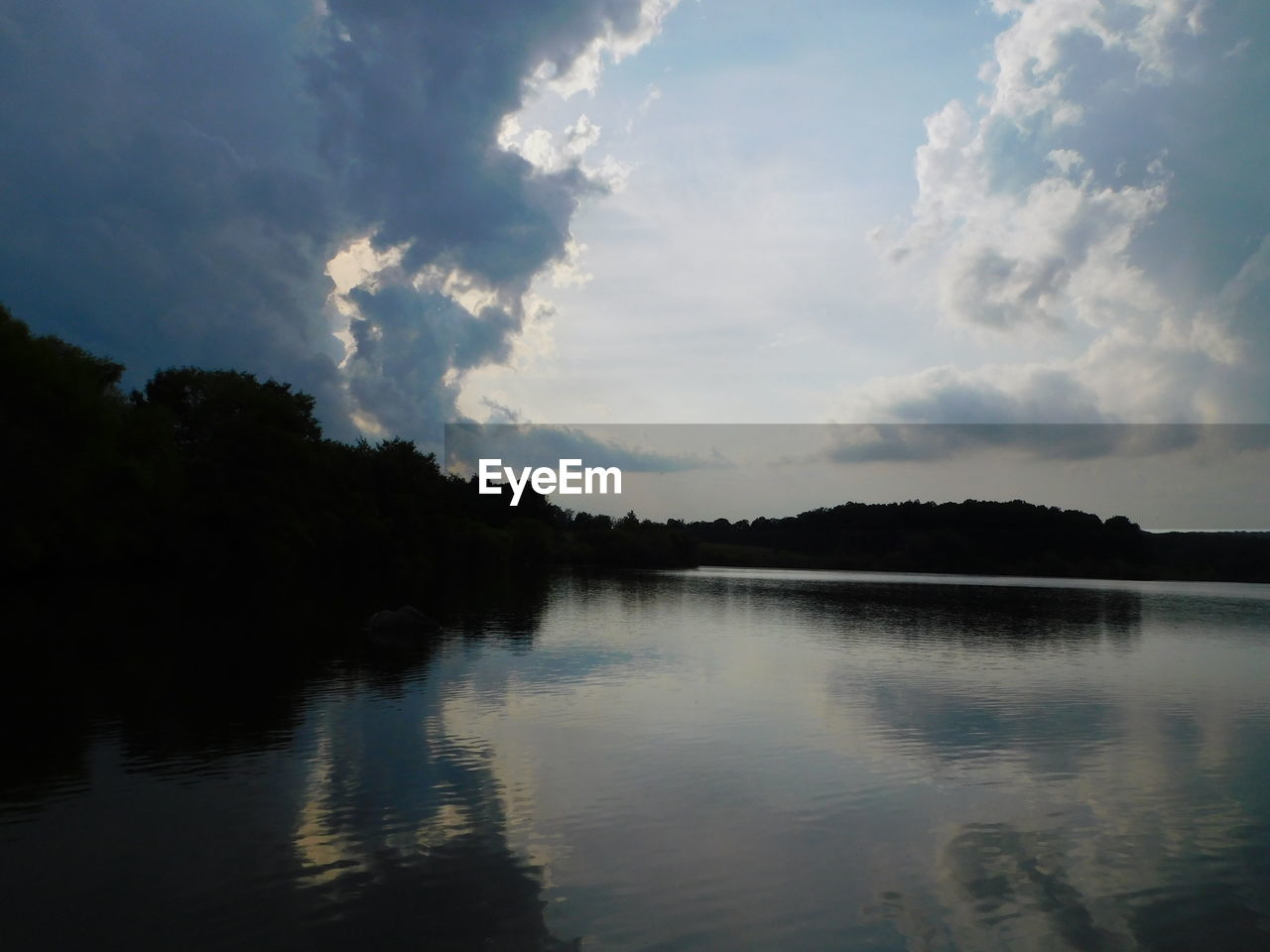 SILHOUETTE TREES BY LAKE AGAINST SKY