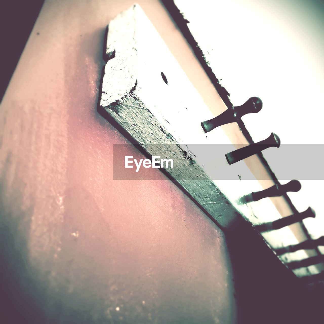 CLOSE-UP OF CROSS ON OLD METAL