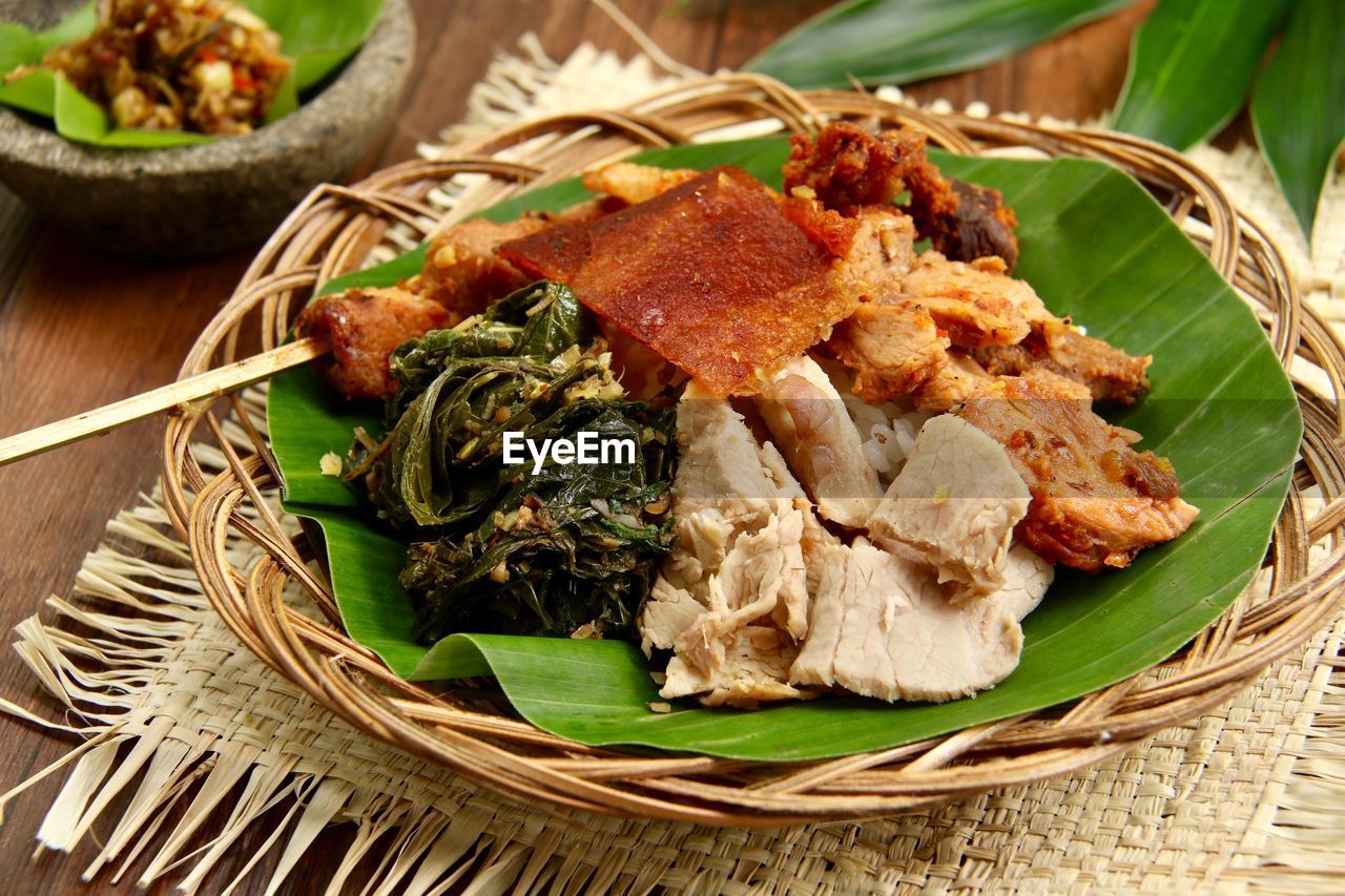 Nasi campur babi guling. balinese rice dish of roast pork and other side dishes