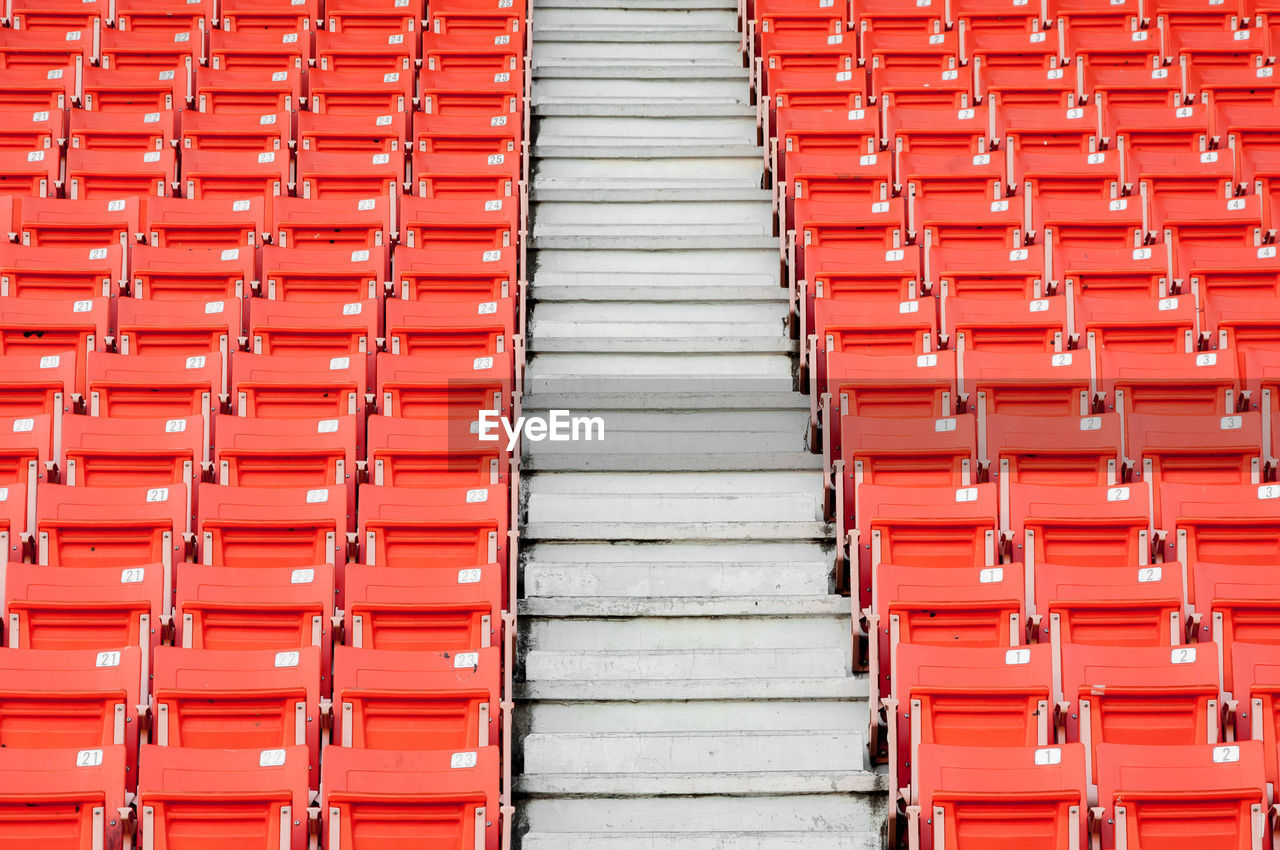 FULL FRAME SHOT OF RED SEATS IN OFFICE