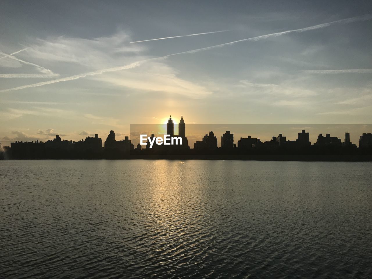 Silhouette of buildings against sky during sunset.