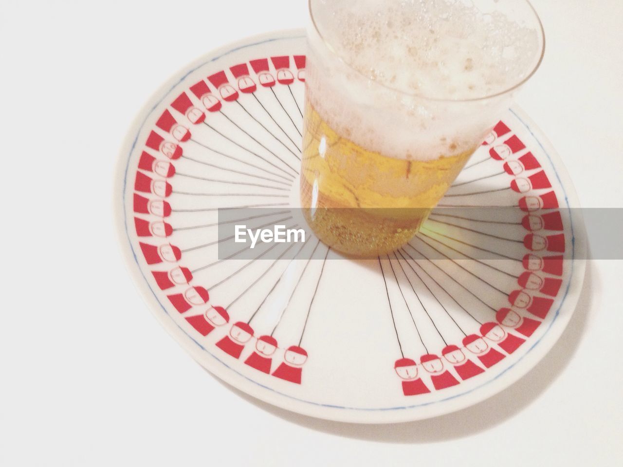 Drink glass in plate on white background