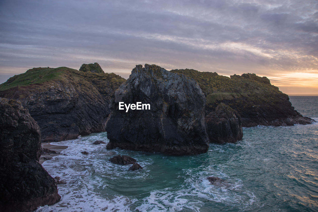 Scenic view of sea against sky during sunset at kynance cove