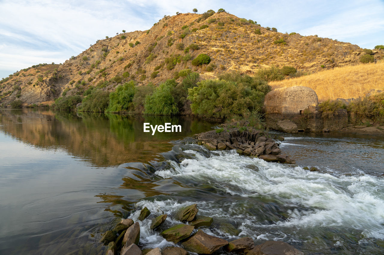 Watermills from the guadiana in mértola, where you can see a small waterfall due to the current 