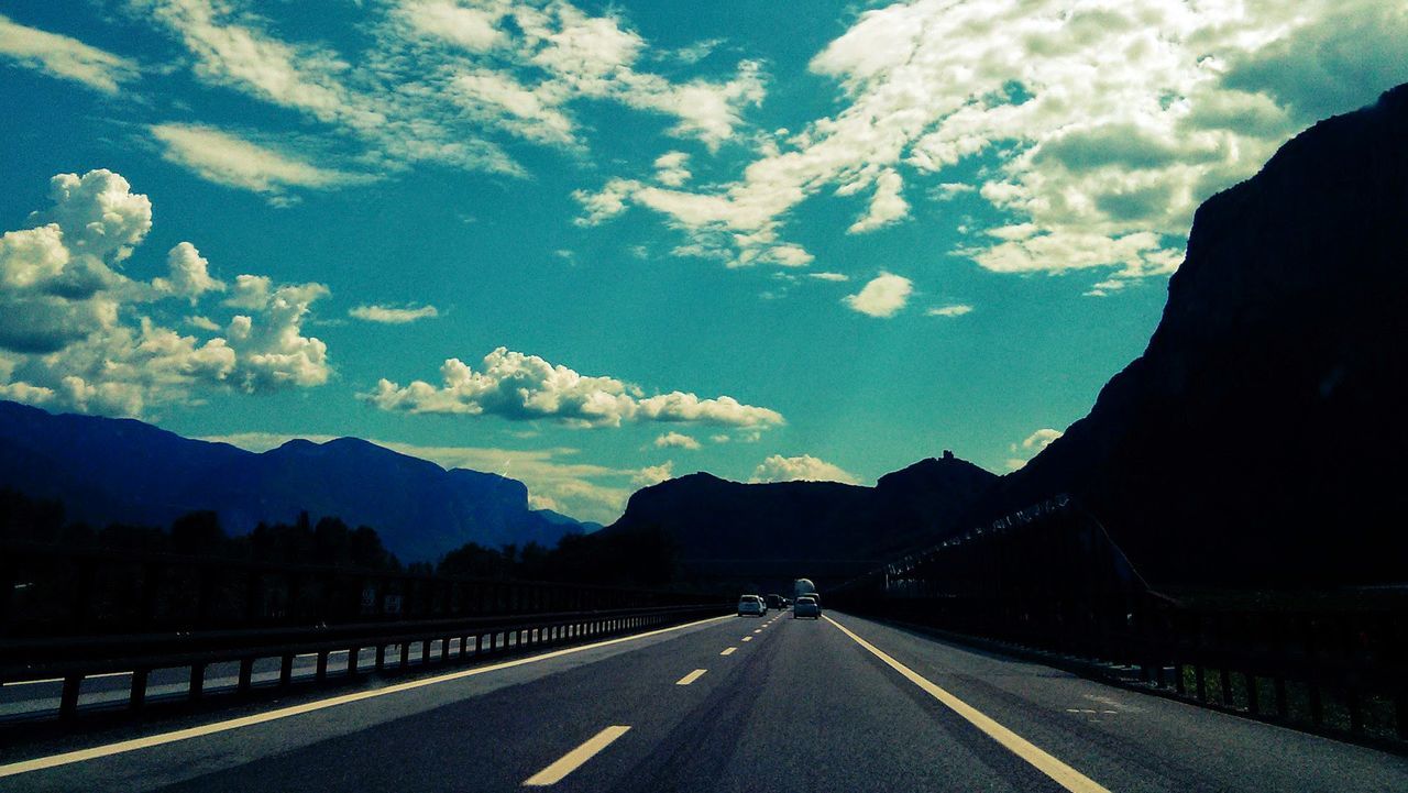 Empty country road along silhouette landscape