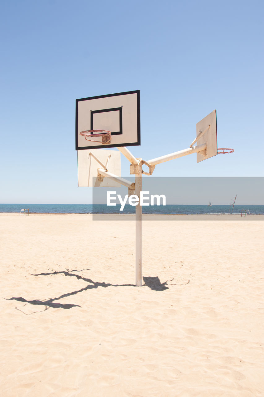 Basketball court in the middle of the beach in a sunny day