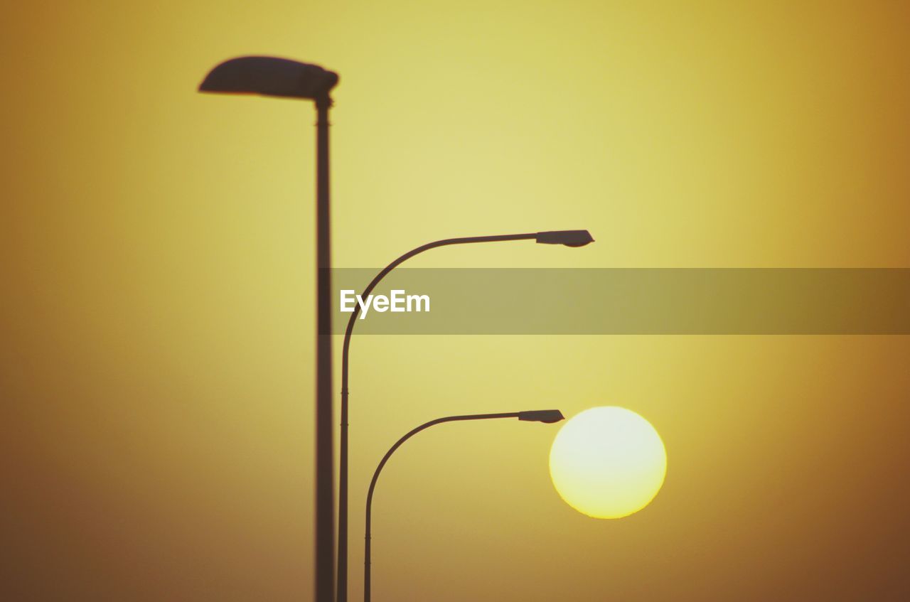 Close-up of street light and sunrise 