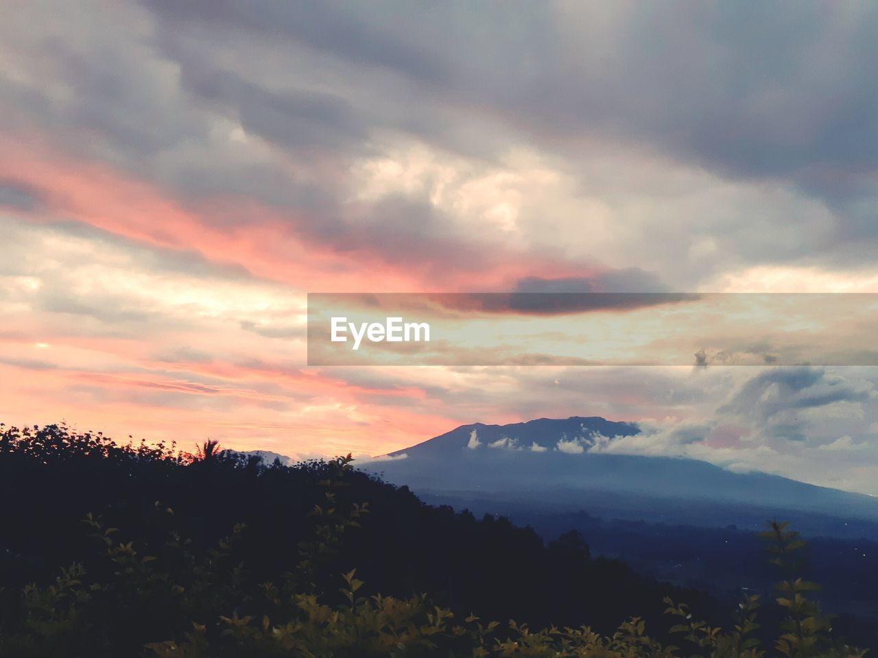 SCENIC VIEW OF SILHOUETTE MOUNTAIN AGAINST ORANGE SKY