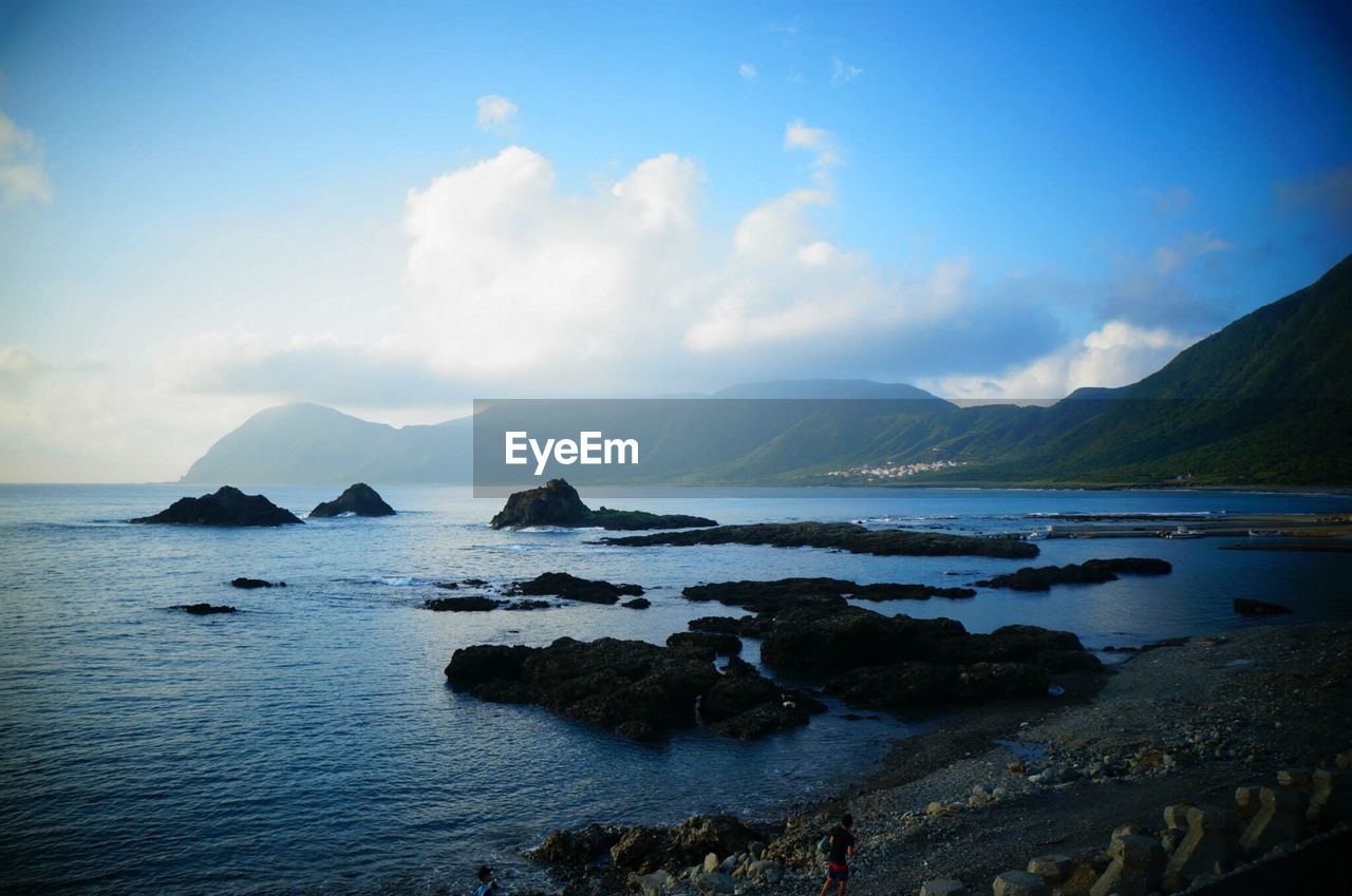 Scenic view of sea against cloudy sky