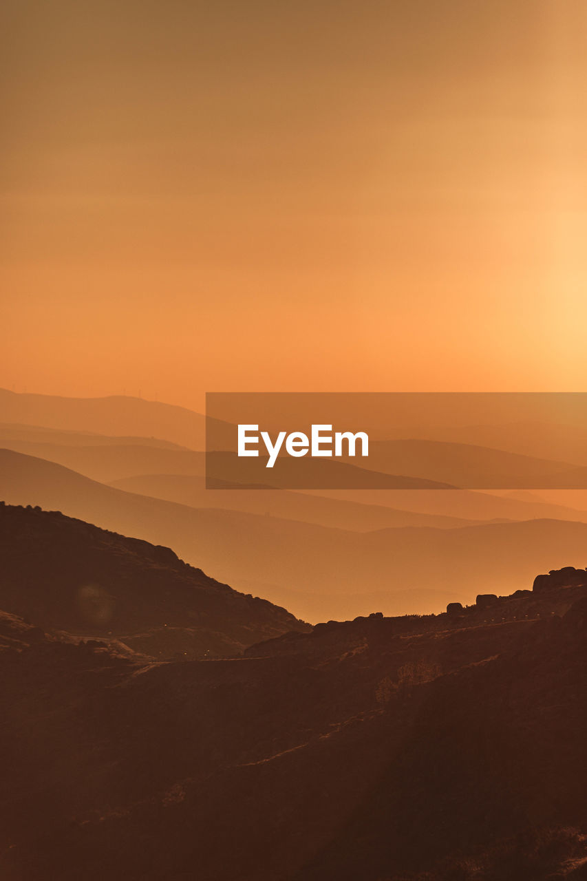 scenic view of silhouette mountains against sky during sunset