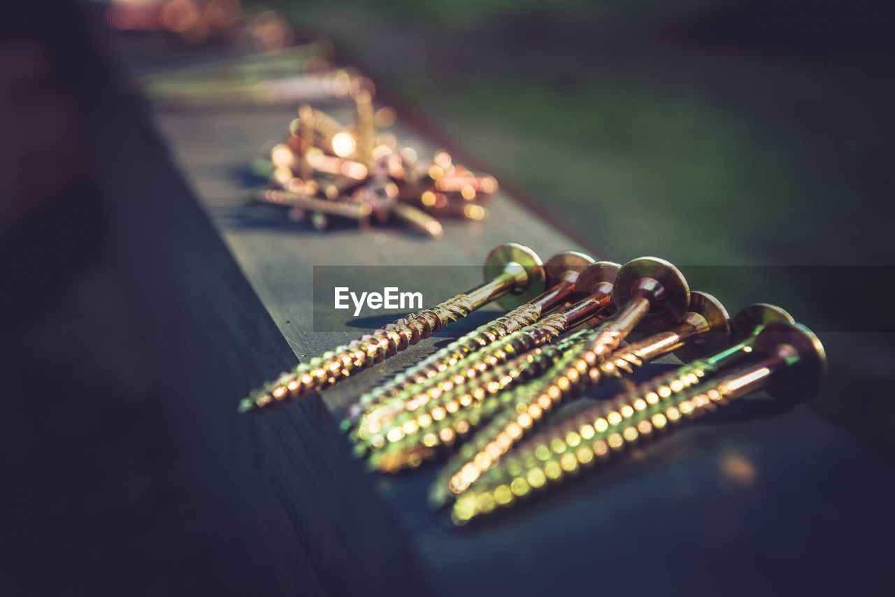 Close-up of screws on table