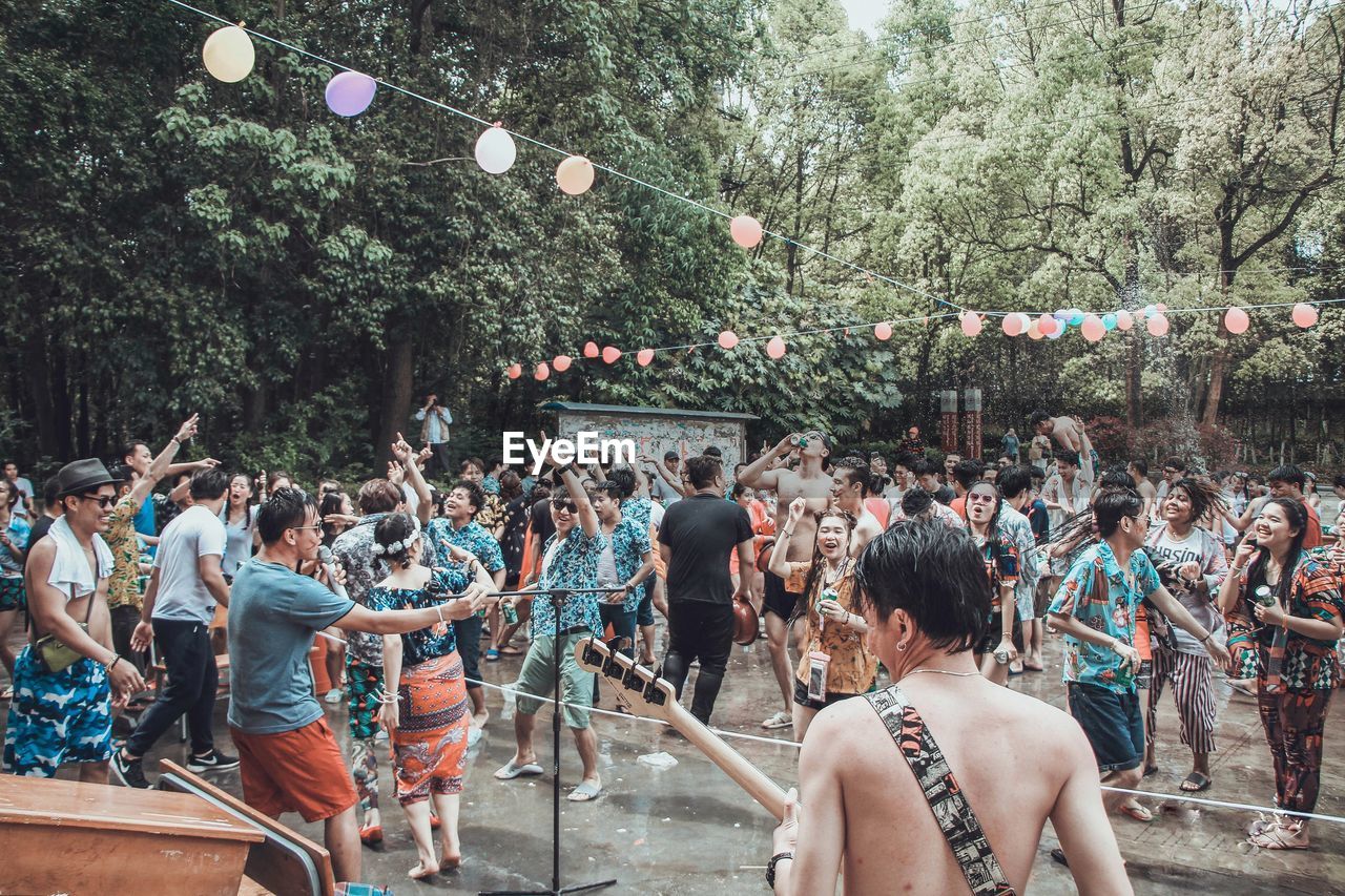 People dancing in city during celebration