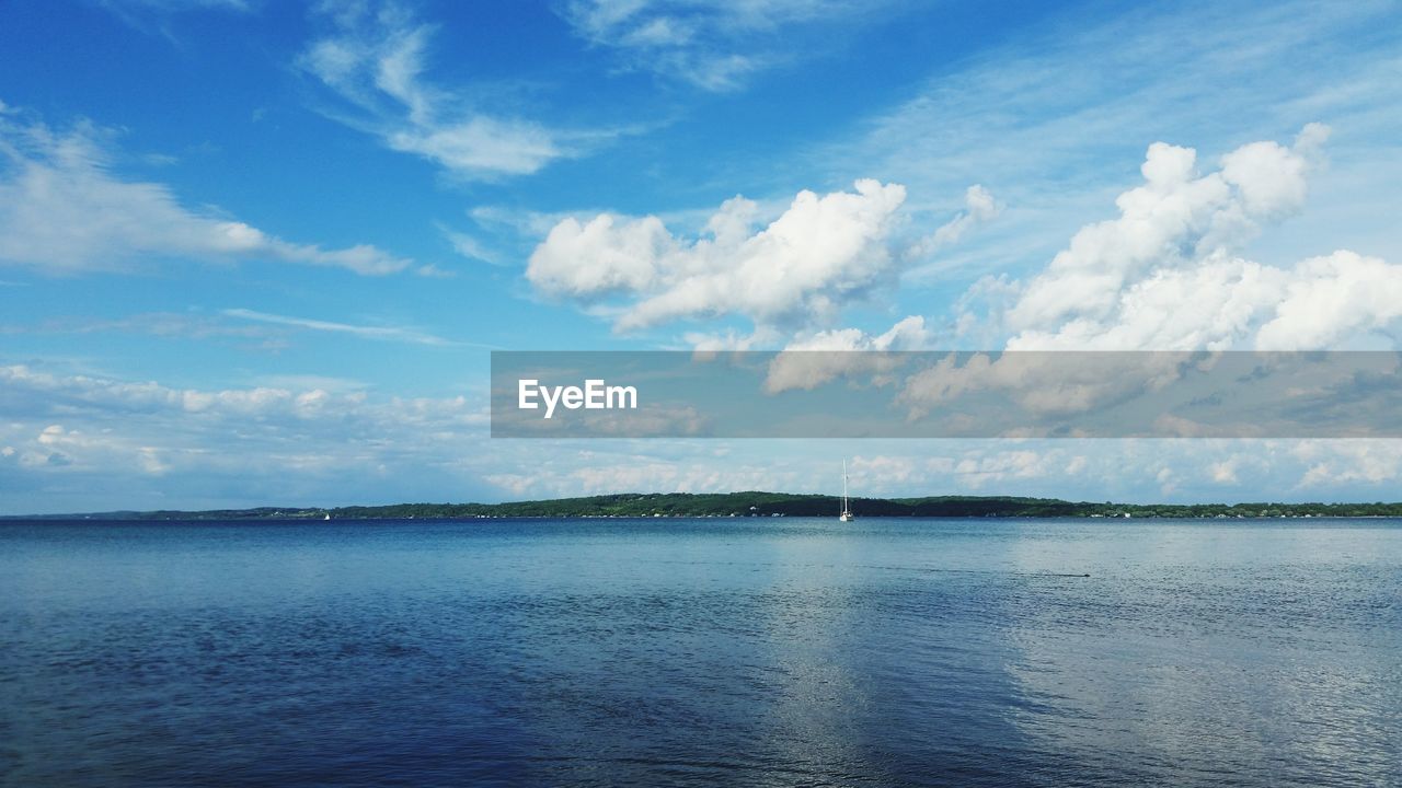 Scenic view of sea against cloudy sky