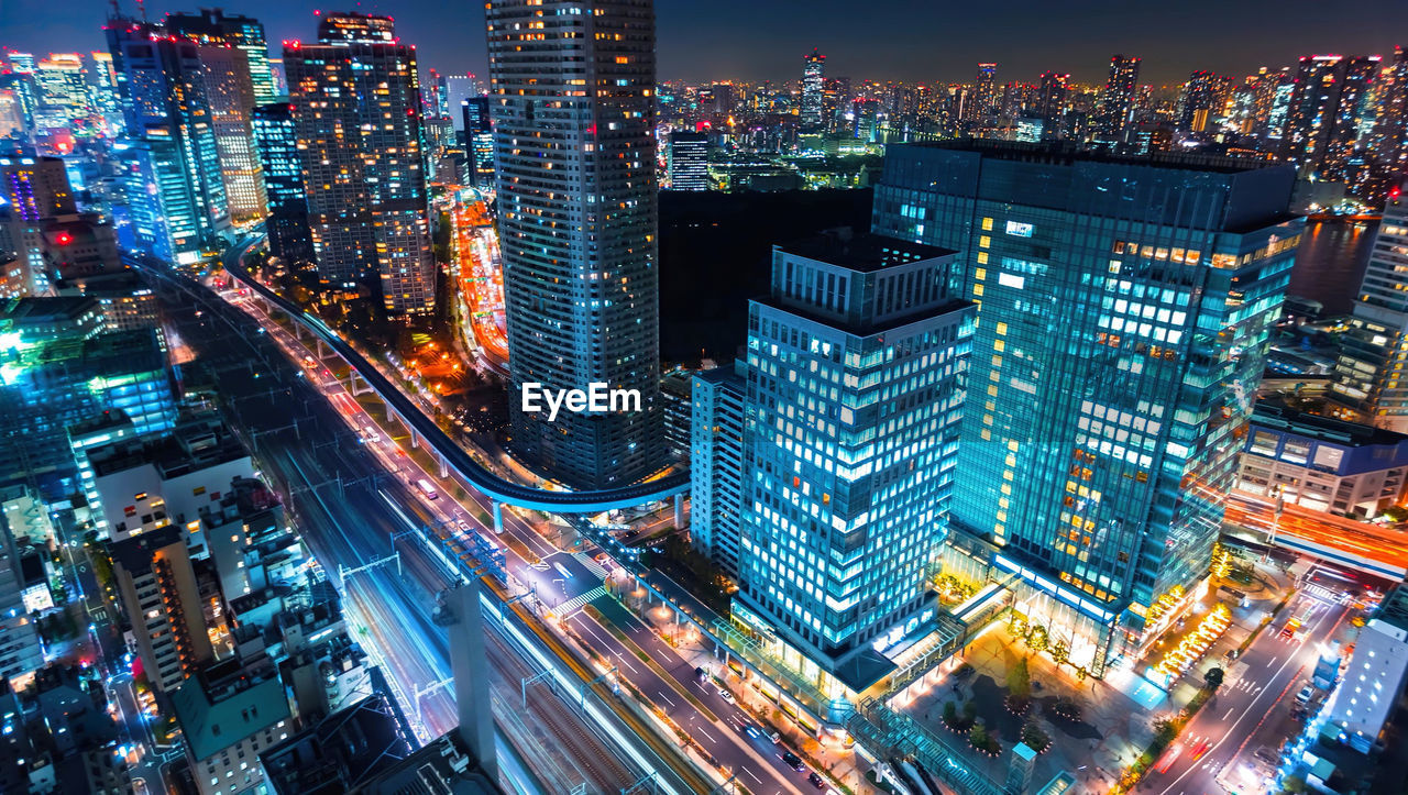 High angle view of illuminated city buildings at night