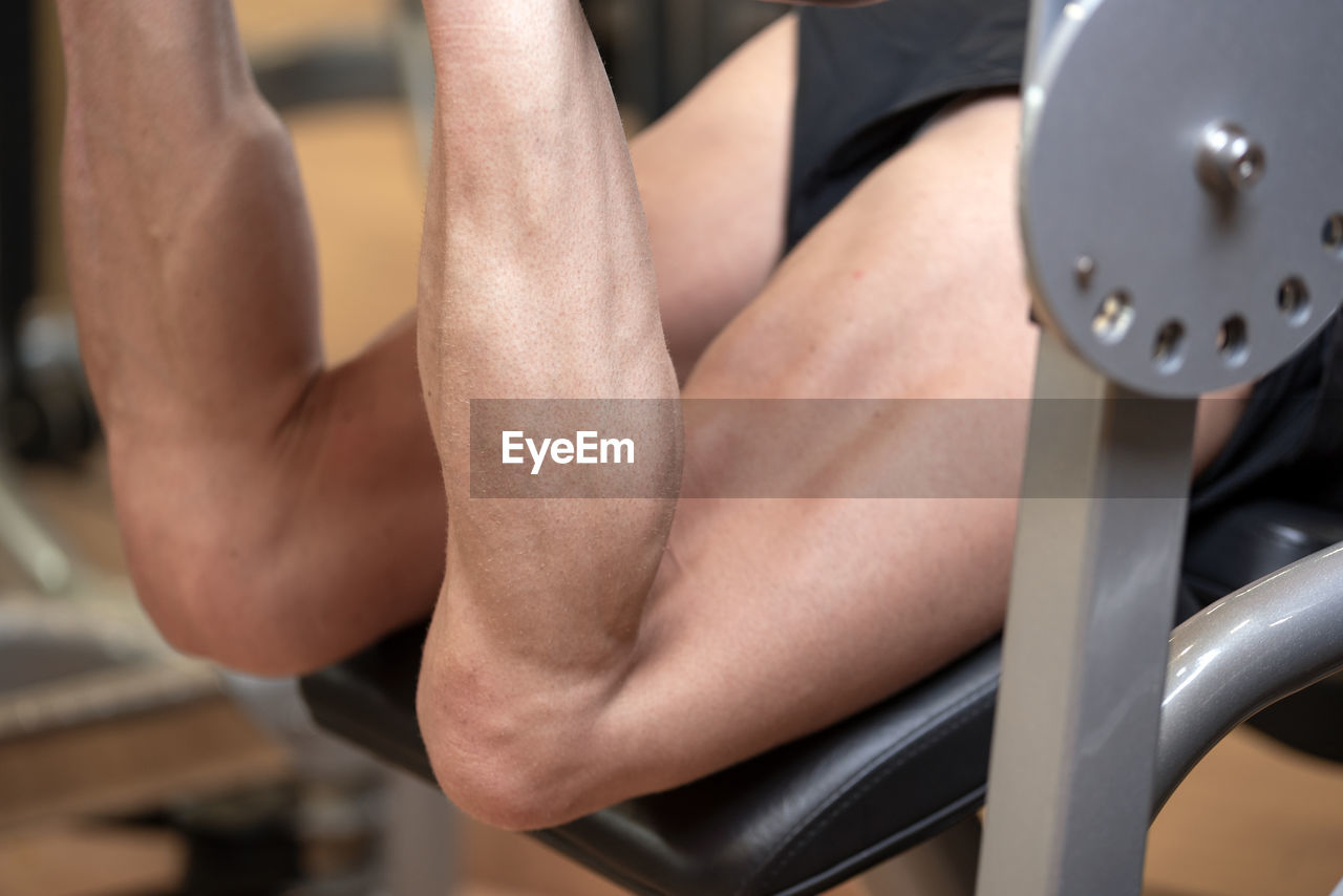 Low section of man exercising in gym