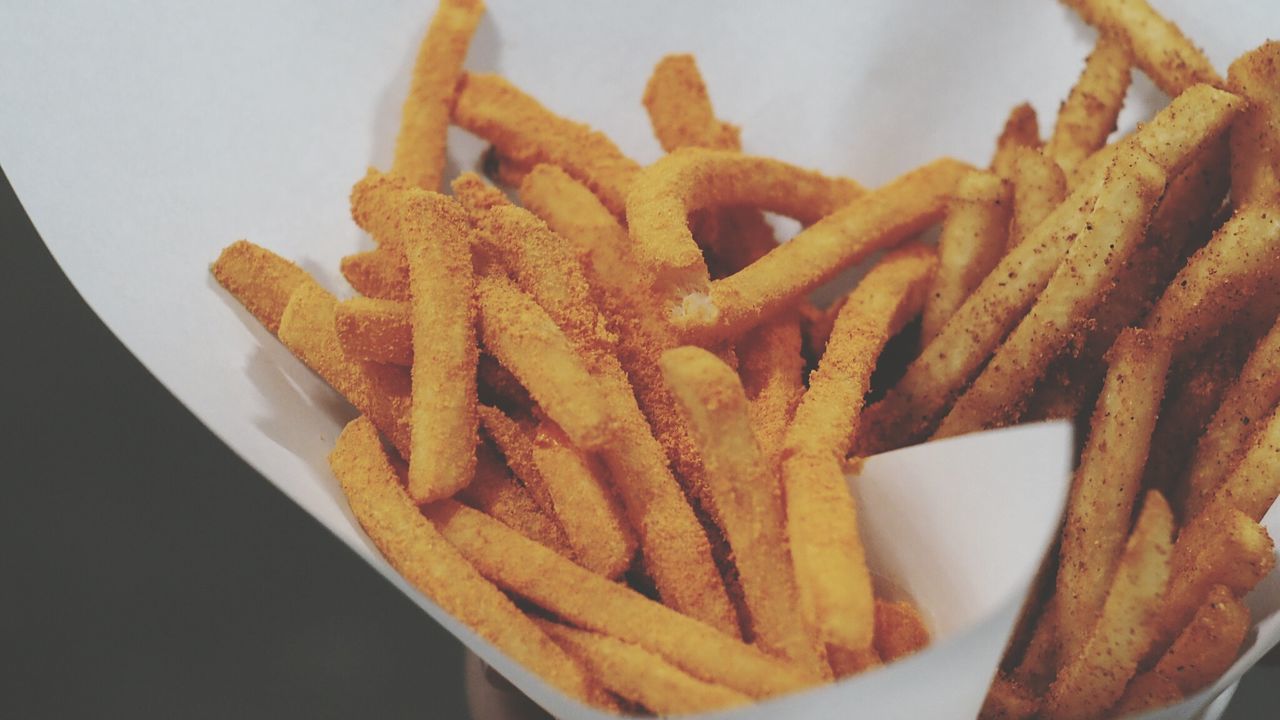 Close-up of french fries in paper