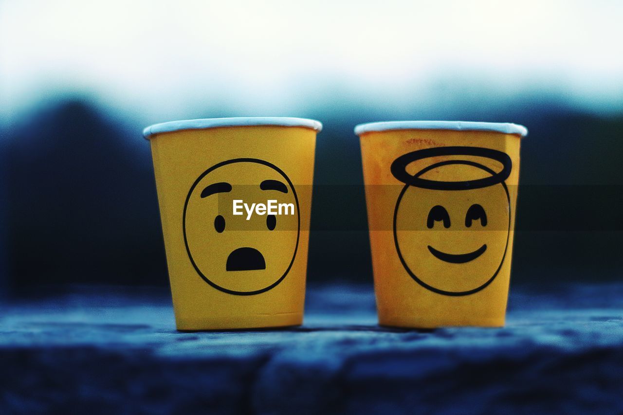 Close-up of disposable cups with anthropomorphic face