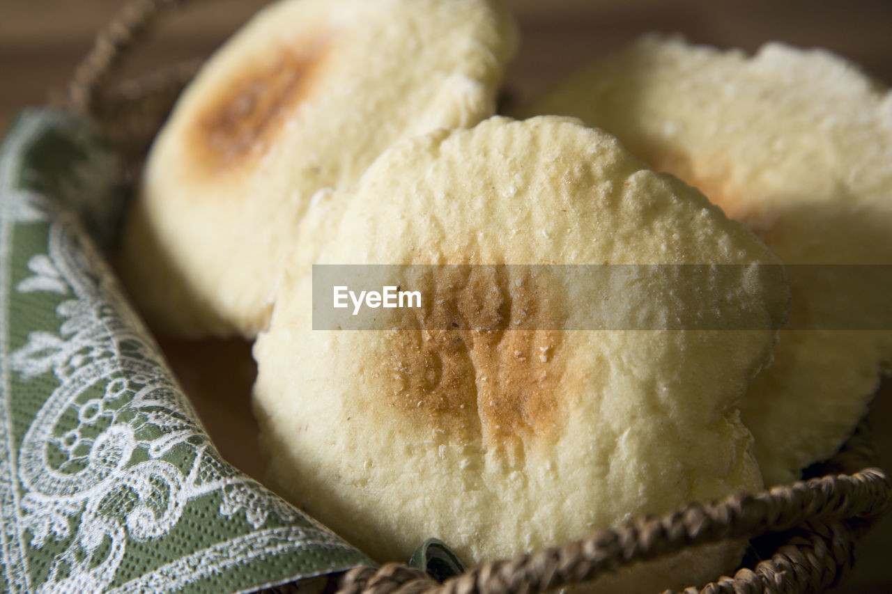 CLOSE-UP OF BREAD ON WHITE TABLE