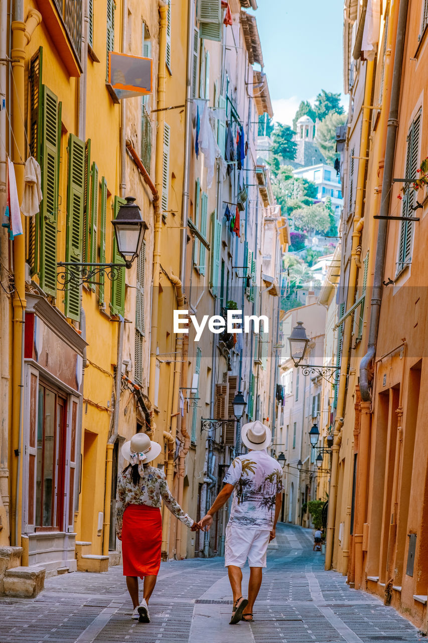 rear view of people walking on street in city