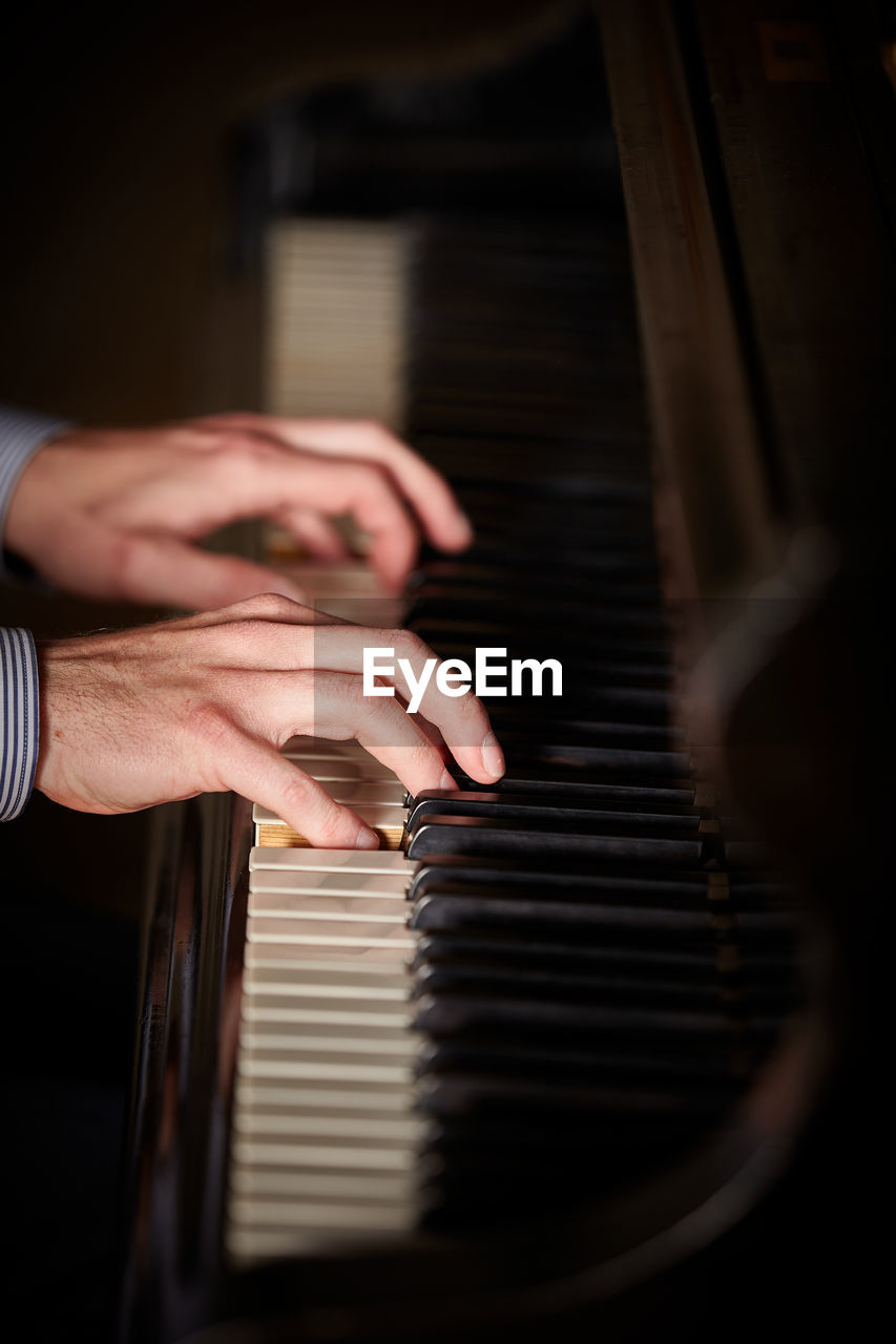 PERSON PLAYING PIANO