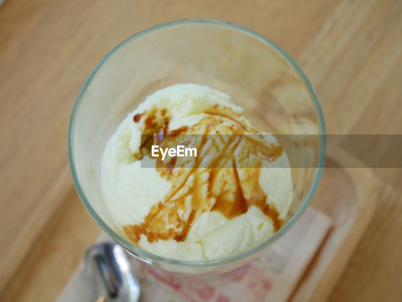 CLOSE-UP OF ICE CREAM IN GLASS ON TABLE