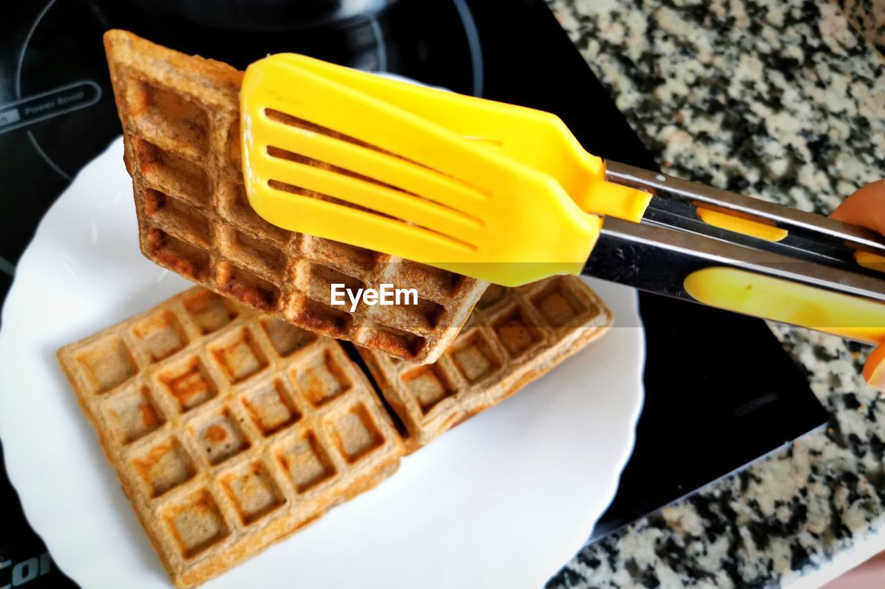 waffle, food, meal, food and drink, dish, breakfast, belgian waffle, sweet food, freshness, dessert, indoors, kitchen utensil, sweet, fast food, close-up, unhealthy eating, high angle view, snack, temptation
