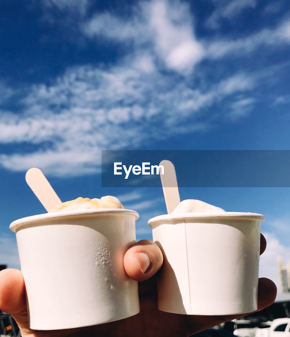 HAND HOLDING COFFEE CUP AND TEA
