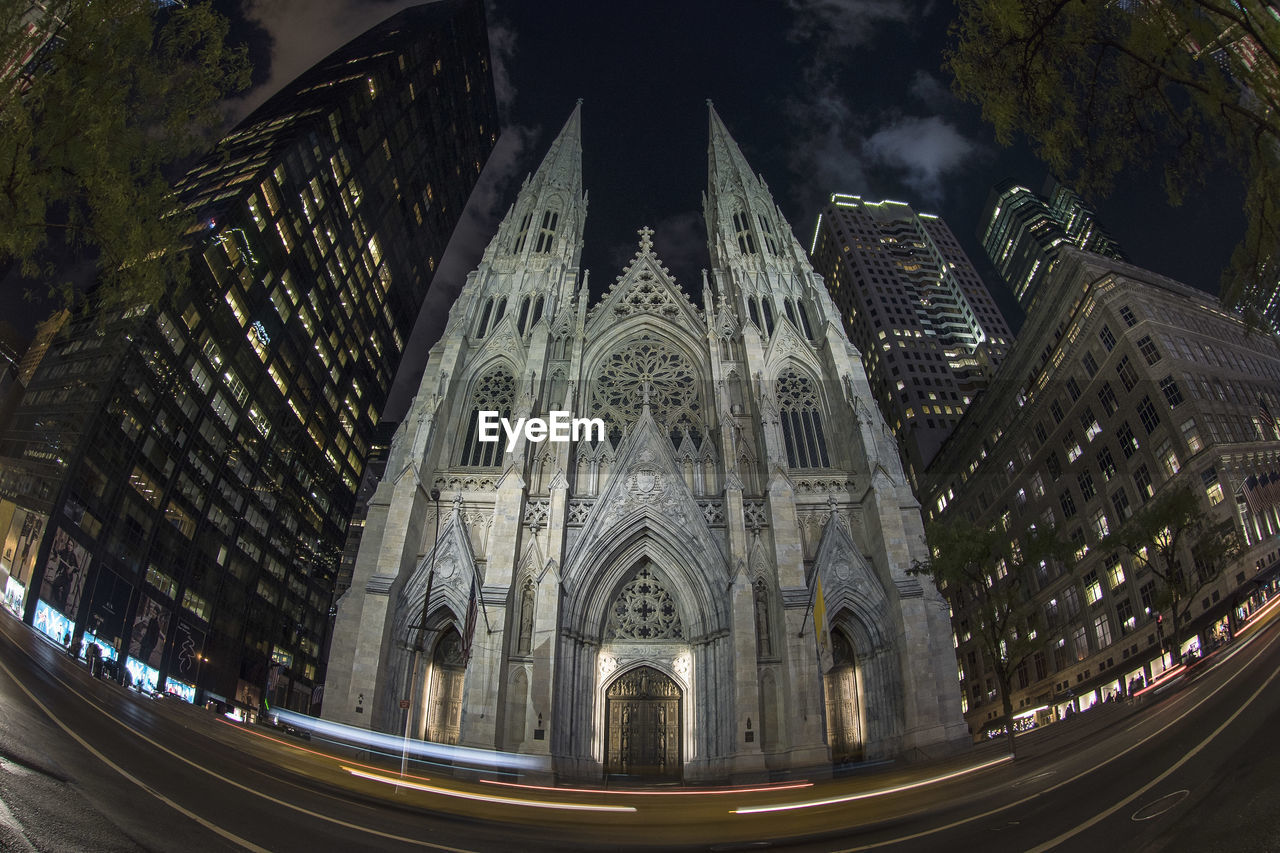 Fish eye lens view of illuminated buildings in city at night