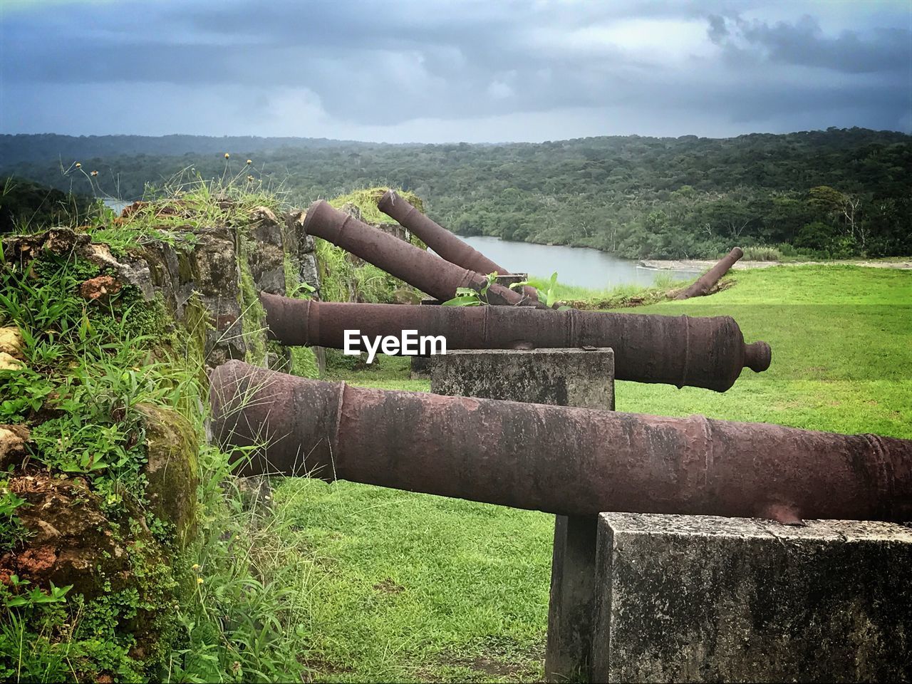 Close-up of wooden fence on field against sky