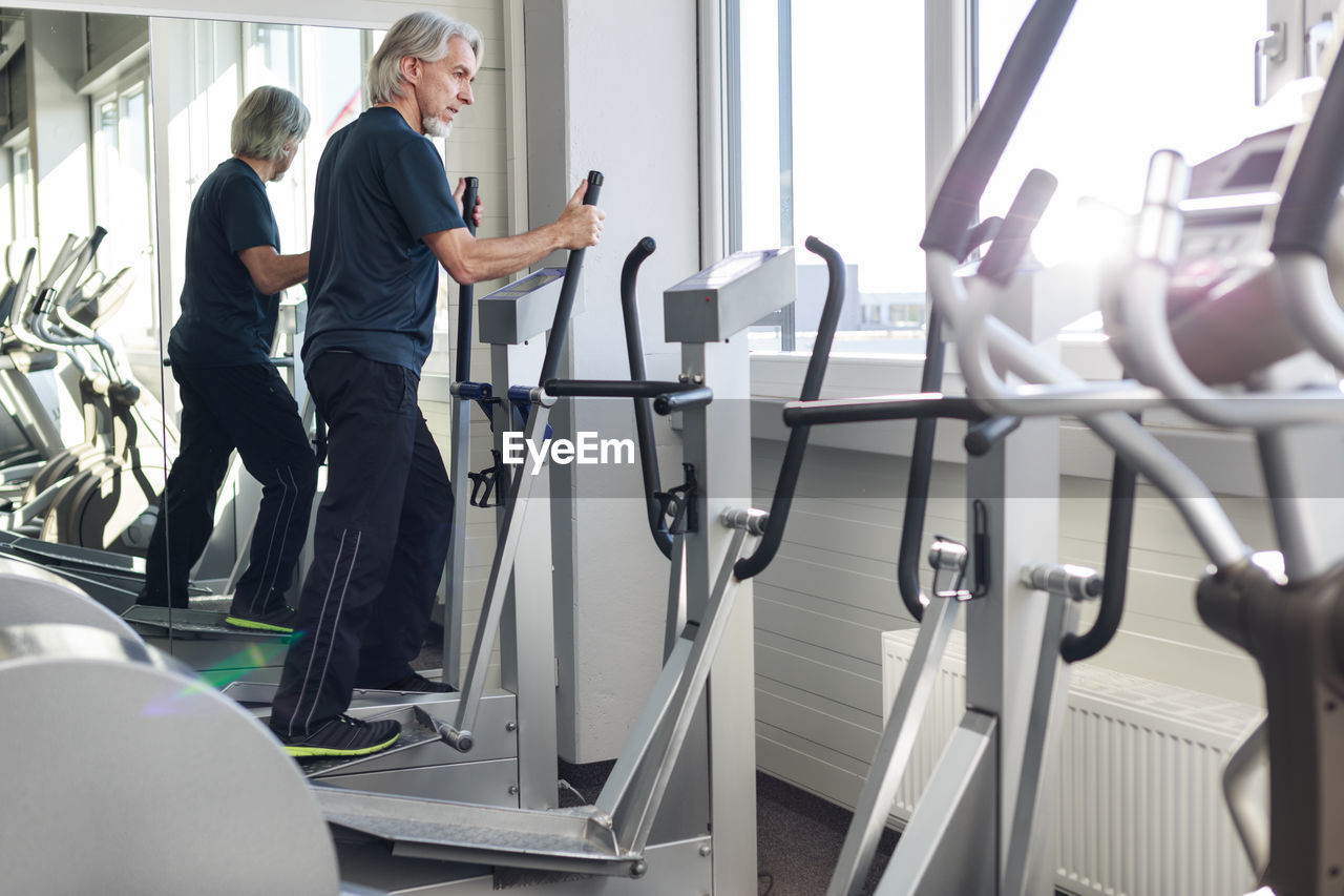 Full length of man exercising in gym