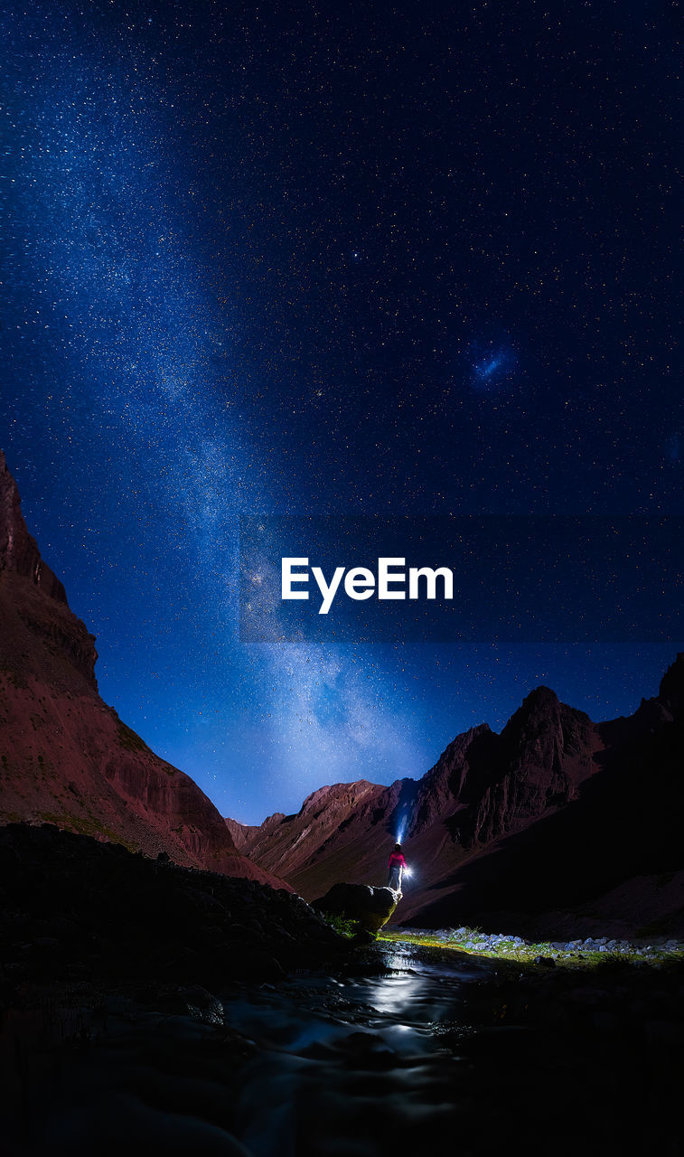 Scenic view of illuminated mountains against sky at night