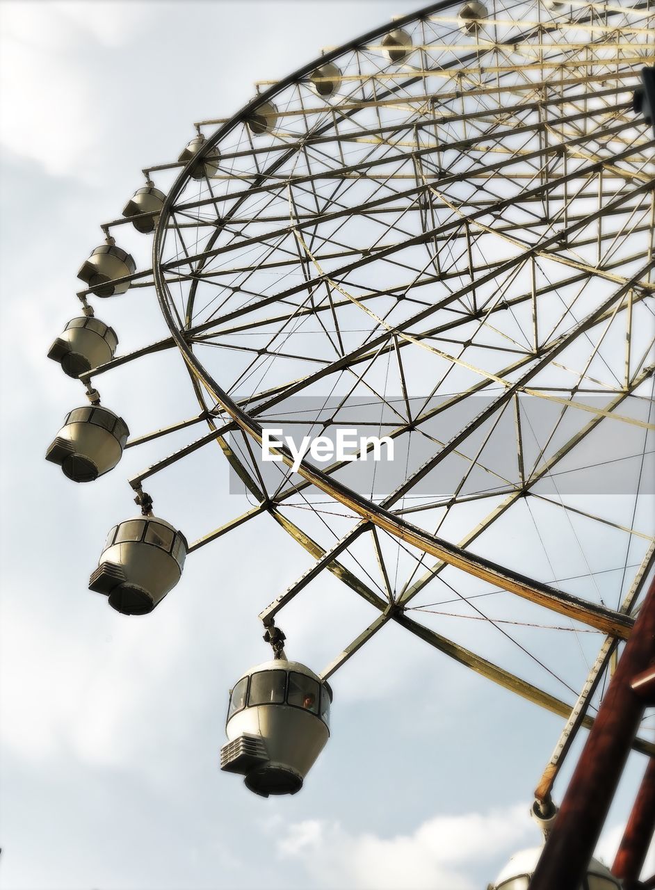 Low angle view of ferris wheel against sky