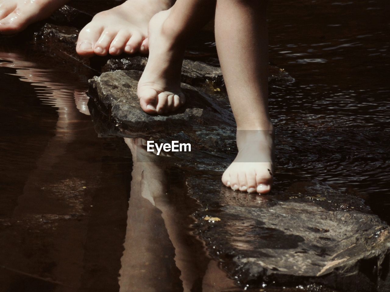 WOMAN STANDING IN WATER