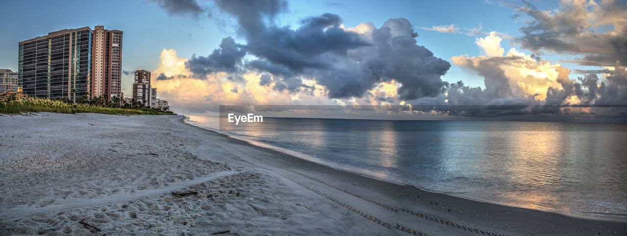 PANORAMIC SHOT OF SEA AND BUILDINGS AGAINST SKY