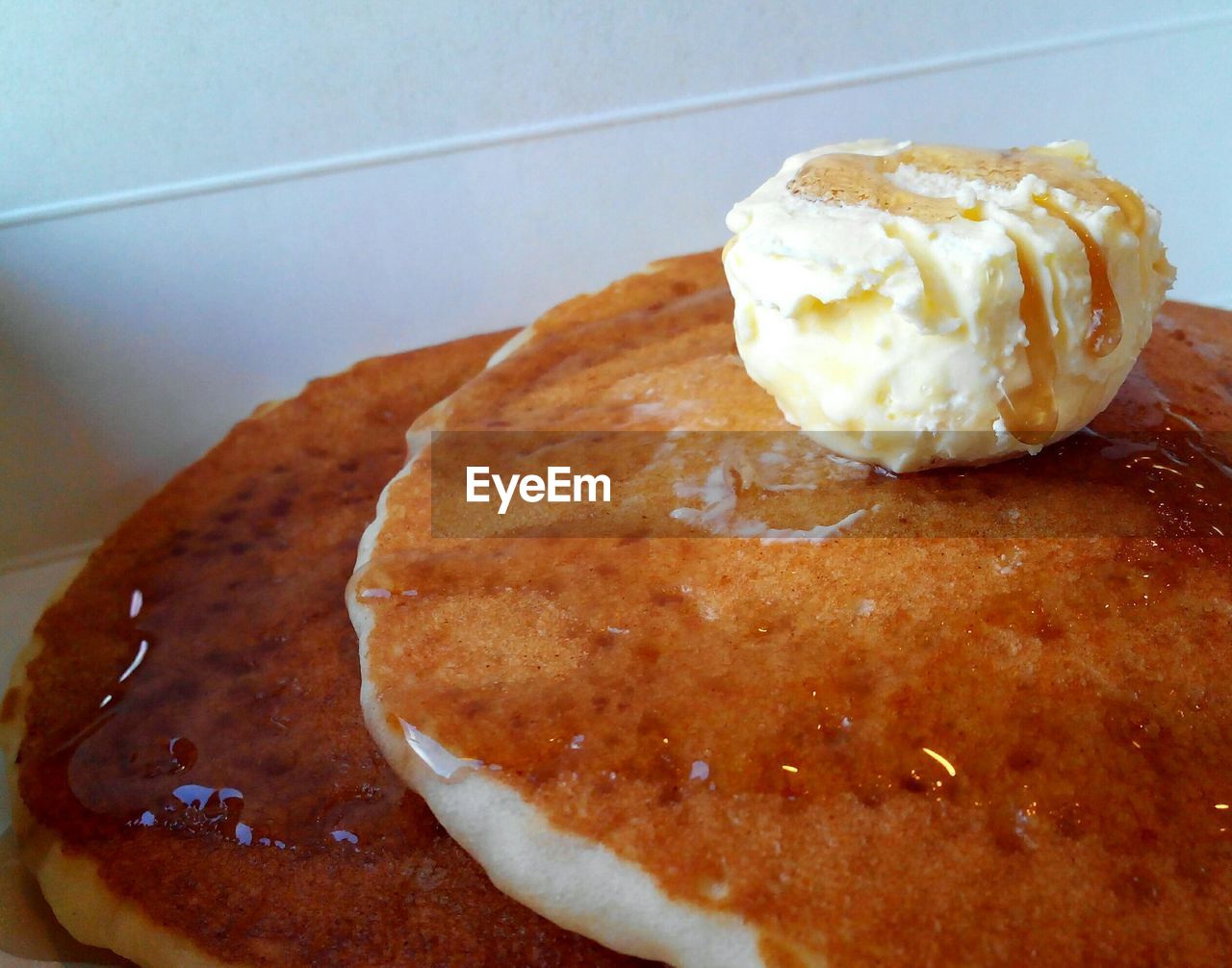 Close-up of pancakes and ice cream in plate