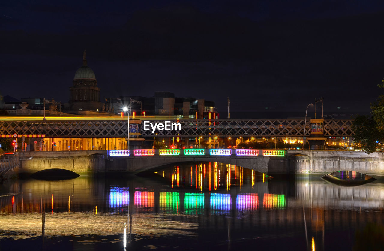 ILLUMINATED BRIDGE OVER RIVER